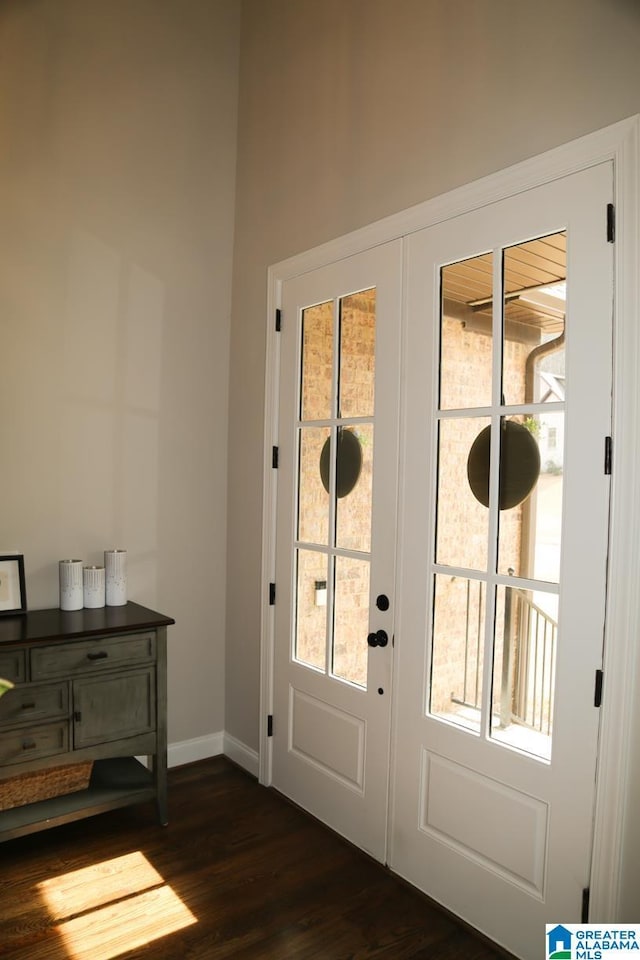 doorway to outside with baseboards and dark wood-style flooring