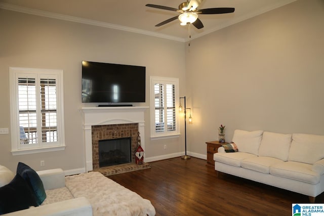 living area with dark wood-style floors, a brick fireplace, crown molding, and baseboards