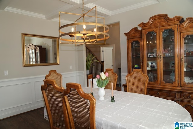 dining room featuring a notable chandelier, ornamental molding, wood finished floors, stairway, and wainscoting