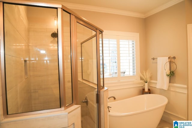 full bathroom featuring ornamental molding, a stall shower, and a freestanding tub