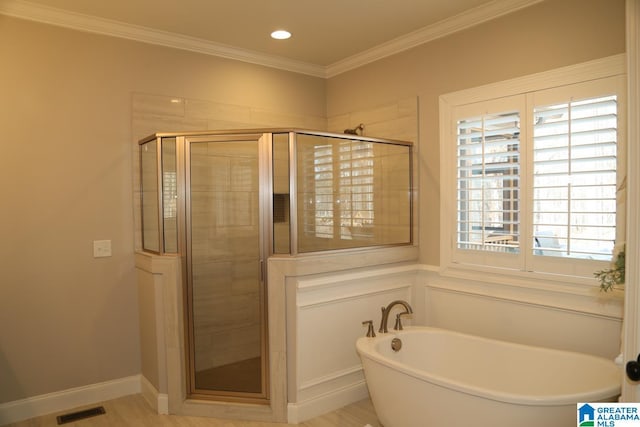 bathroom with visible vents, a soaking tub, ornamental molding, and a shower stall