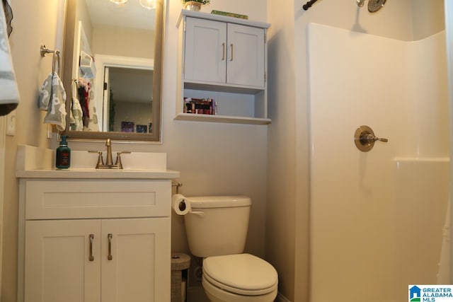 bathroom with vanity, toilet, and walk in shower