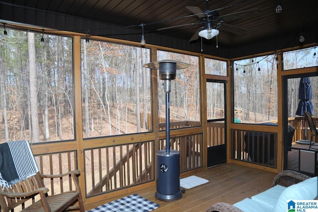 sunroom / solarium with wood ceiling and ceiling fan