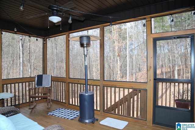 sunroom / solarium featuring wooden ceiling, a ceiling fan, and vaulted ceiling