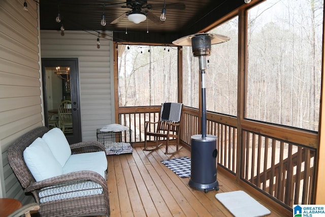 sunroom featuring ceiling fan