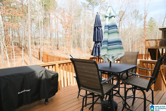 deck featuring area for grilling and fence