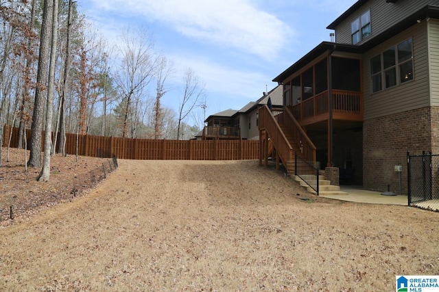 view of yard featuring stairway, a patio, and fence