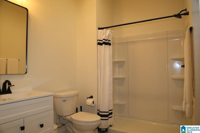 bathroom with vanity, a shower with shower curtain, and toilet