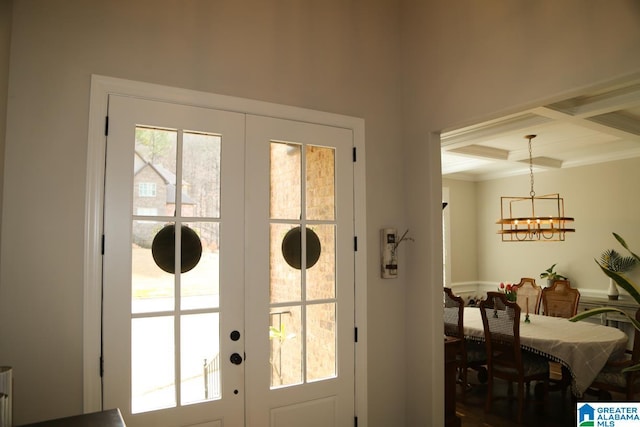 entryway with a chandelier, beamed ceiling, french doors, and coffered ceiling