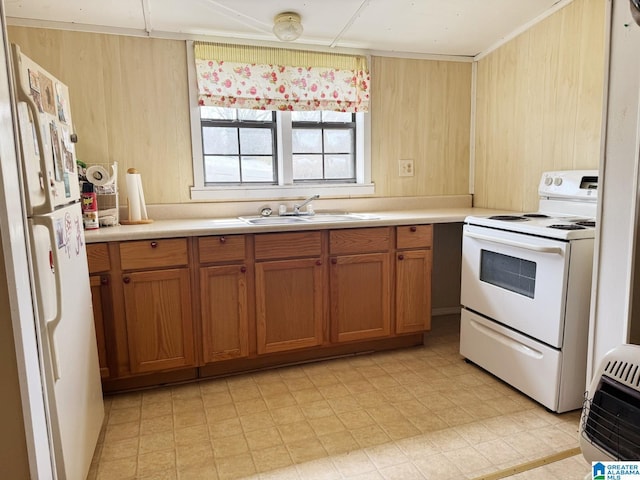 kitchen featuring white appliances, light countertops, a sink, and light floors