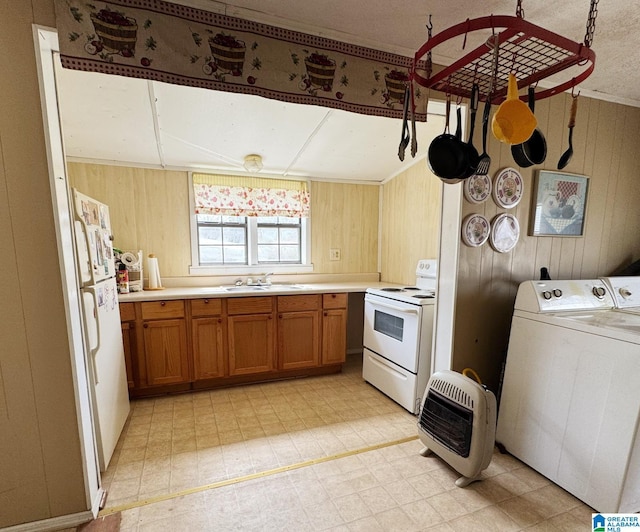 kitchen featuring brown cabinets, light floors, heating unit, wood walls, and white appliances