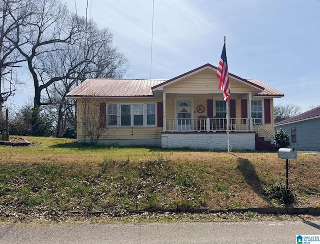 view of front of home featuring covered porch and metal roof