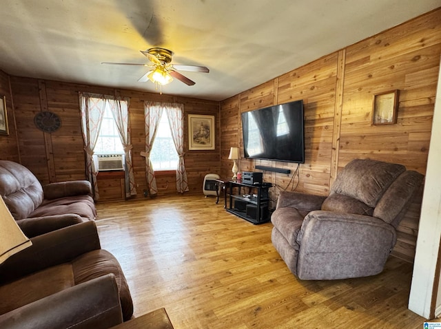 living area with light wood finished floors, ceiling fan, and cooling unit