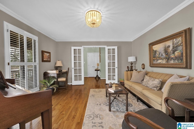 living area featuring a notable chandelier, french doors, wood finished floors, and crown molding