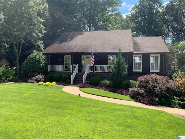 ranch-style home featuring a porch, a front yard, roof with shingles, and stairway