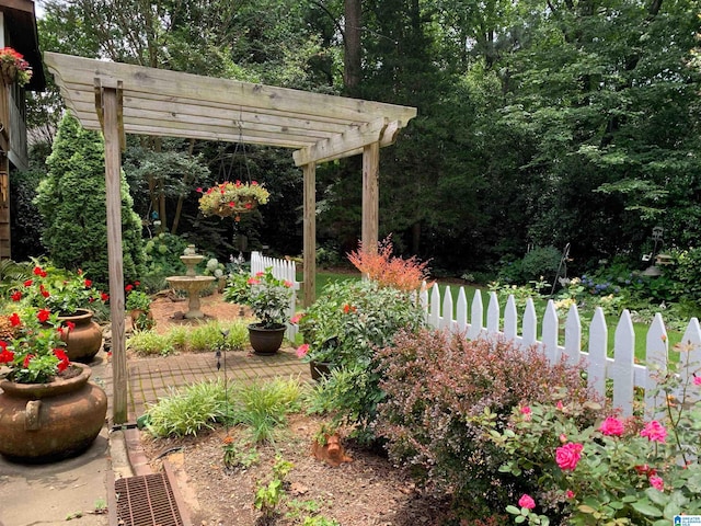 view of yard featuring fence and a pergola