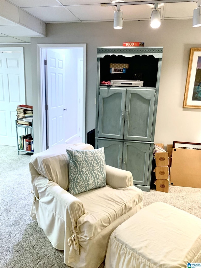 interior space featuring ceiling fan and a drop ceiling