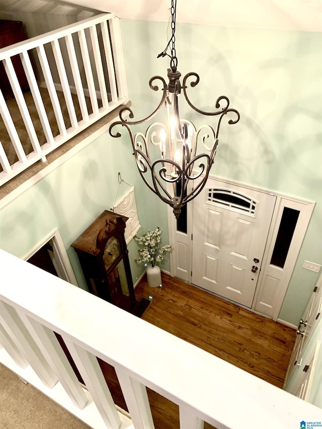 entrance foyer with a chandelier and wood finished floors