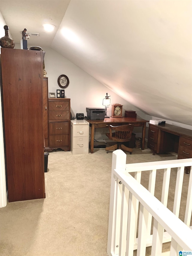 home office with lofted ceiling and carpet flooring