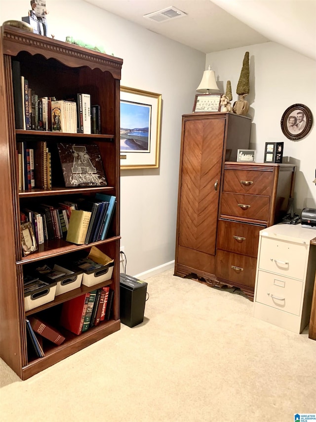 sitting room featuring visible vents, vaulted ceiling, light carpet, and baseboards