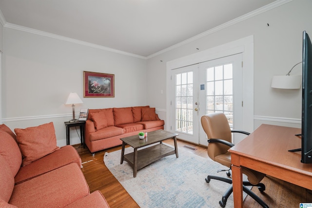 office with wood finished floors, visible vents, baseboards, french doors, and crown molding