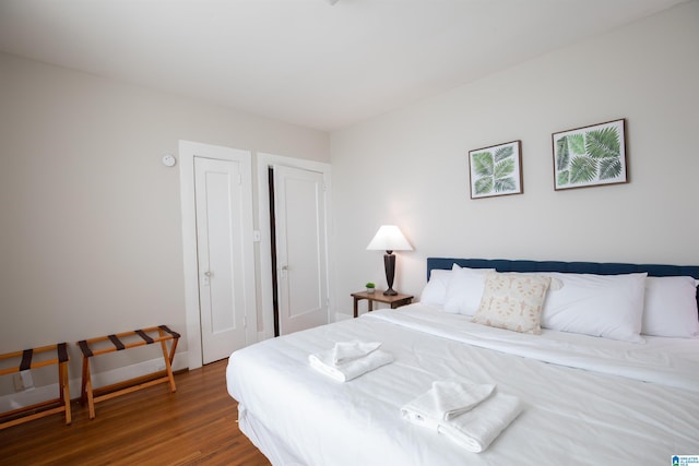 bedroom featuring baseboards and wood finished floors