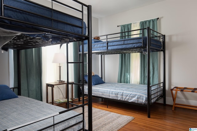 bedroom with wood finished floors and baseboards