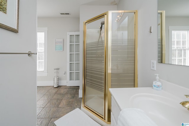 full bath with vanity, visible vents, and a stall shower