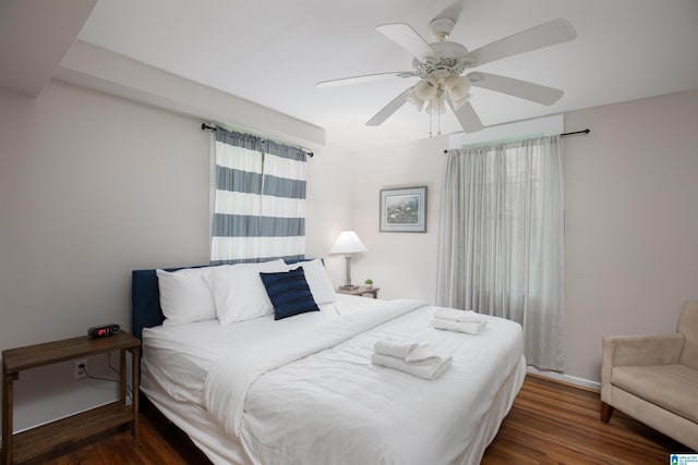 bedroom featuring baseboards, ceiling fan, and wood finished floors