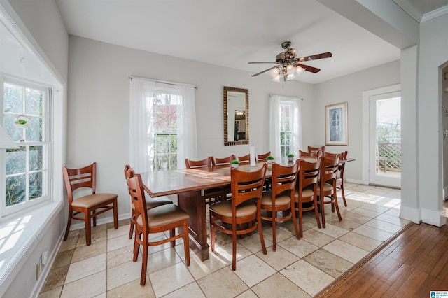 dining space featuring baseboards and a ceiling fan