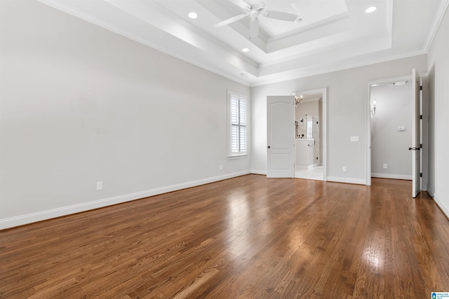 unfurnished bedroom featuring recessed lighting, wood finished floors, baseboards, ornamental molding, and a raised ceiling