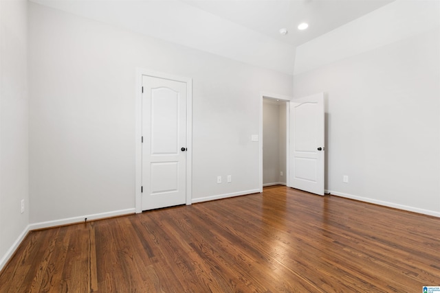 empty room with recessed lighting, wood finished floors, and baseboards