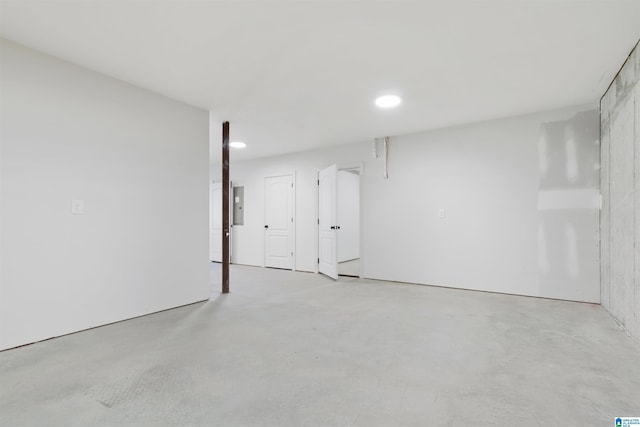 interior space featuring concrete floors, electric panel, and recessed lighting