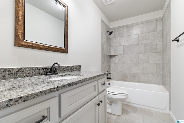 full bathroom featuring toilet, visible vents, vanity, tile patterned floors, and washtub / shower combination