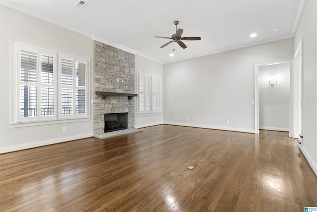 unfurnished living room with ornamental molding, a stone fireplace, wood finished floors, and a ceiling fan