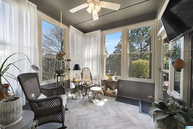 sunroom / solarium featuring a wealth of natural light and ceiling fan