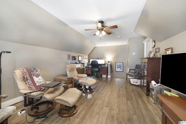 office area with baseboards, ceiling fan, vaulted ceiling, and light wood finished floors