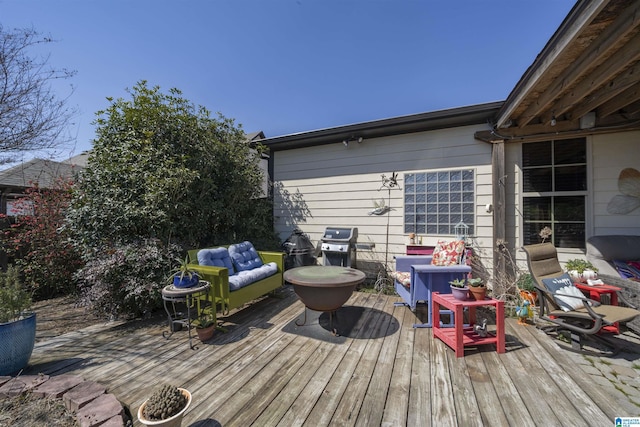 wooden deck with grilling area and outdoor lounge area