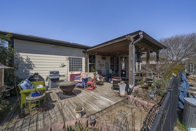 wooden terrace with a grill