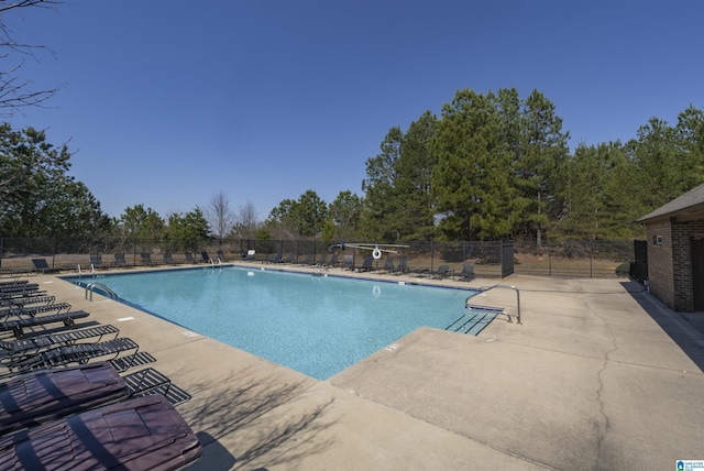 pool featuring a patio and fence