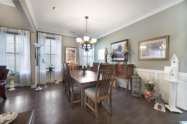 dining space featuring visible vents, an inviting chandelier, crown molding, and hardwood / wood-style flooring