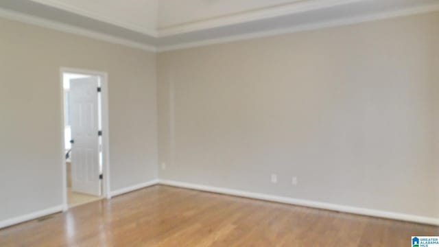 empty room with baseboards and wood finished floors