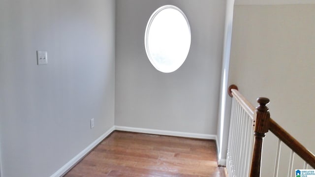 interior space featuring wood finished floors and baseboards