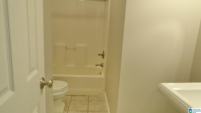 full bathroom with toilet, baseboards, tub / shower combination, and tile patterned floors