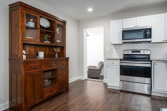 kitchen with stainless steel appliances, tasteful backsplash, glass insert cabinets, and dark wood-style floors