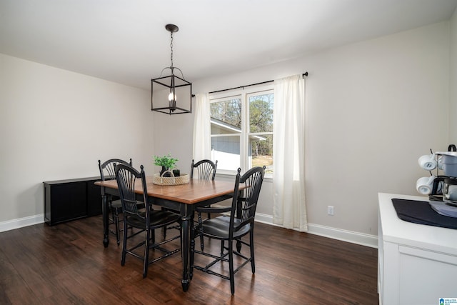 dining area featuring baseboards and dark wood-type flooring