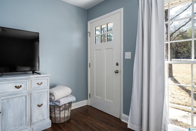 entrance foyer with dark wood finished floors and baseboards