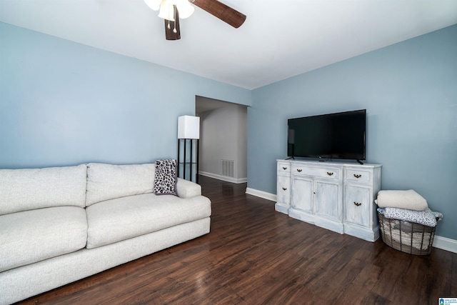 living room featuring visible vents, dark wood-style flooring, a ceiling fan, and baseboards