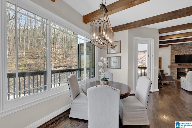 dining area featuring a wealth of natural light, baseboards, and dark wood-type flooring