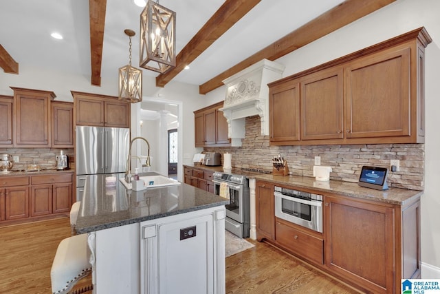 kitchen with stainless steel appliances, brown cabinetry, and a sink